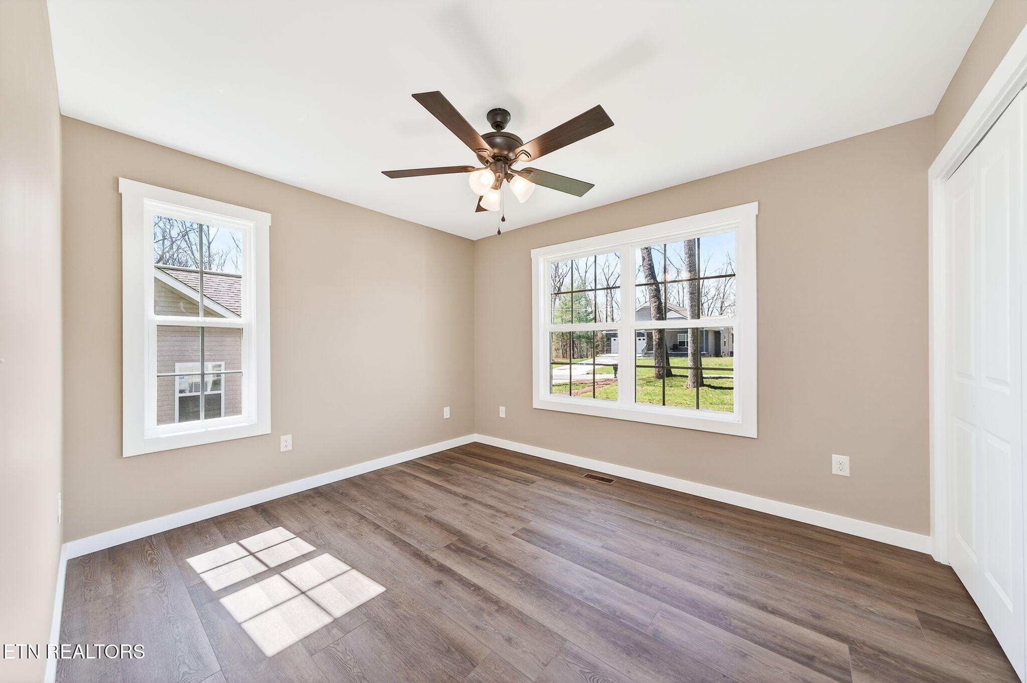 105 Peebles Road Crossville, TN 38558 - Photo 22 of 40 a view of an empty room with a window and wooden floor