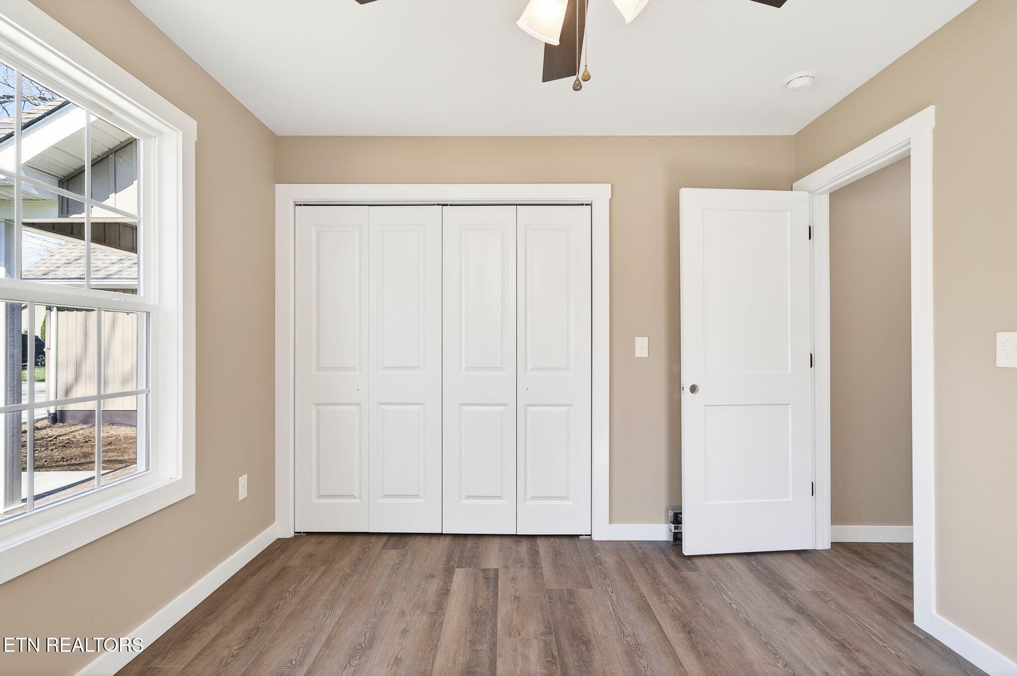 105 Peebles Road Crossville, TN 38558 - Photo 23 of 40 a view of an empty room with wooden floor and a window