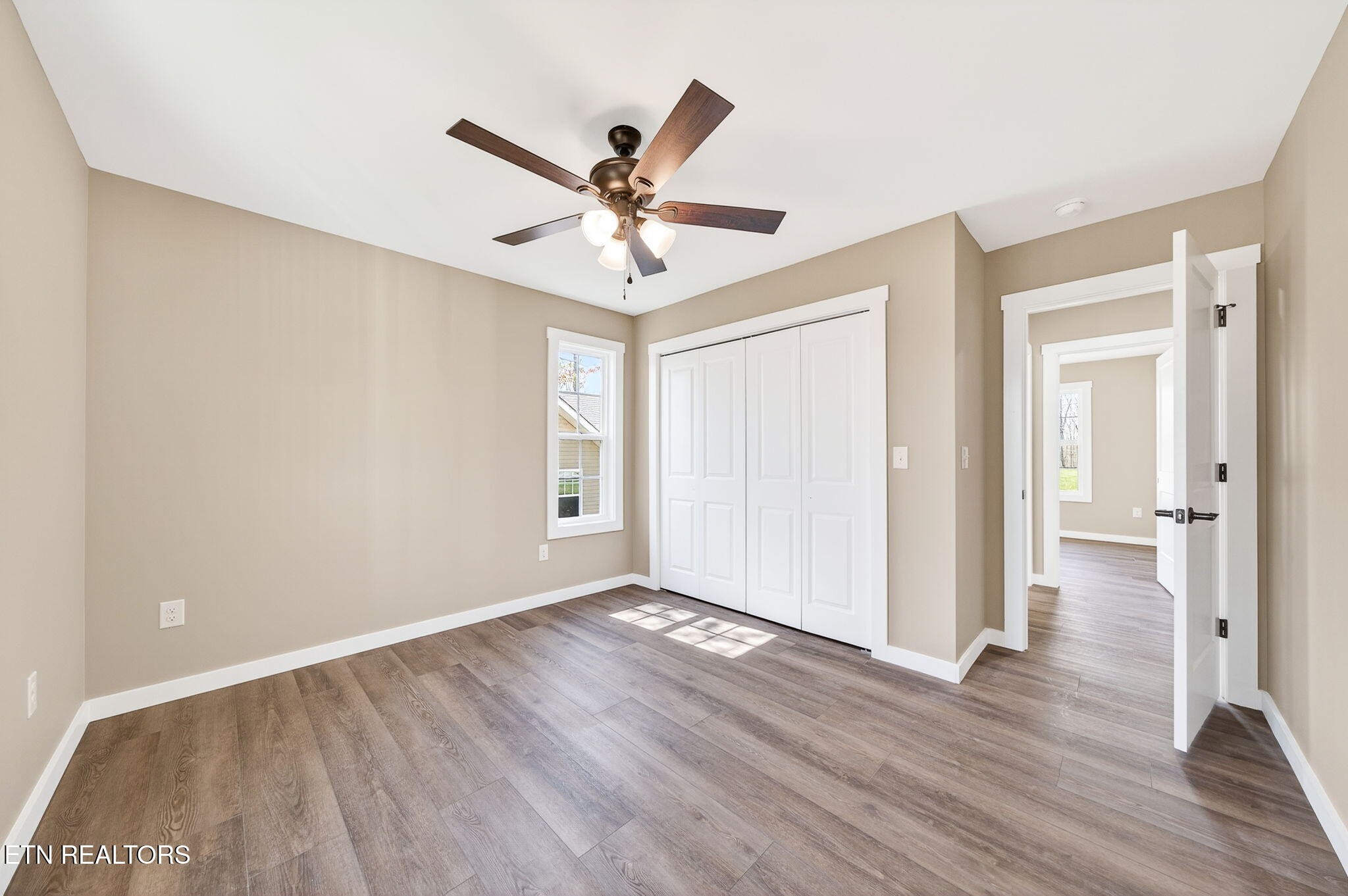 105 Peebles Road Crossville, TN 38558 - Photo 26 of 40 an empty room with wooden floor fan and windows