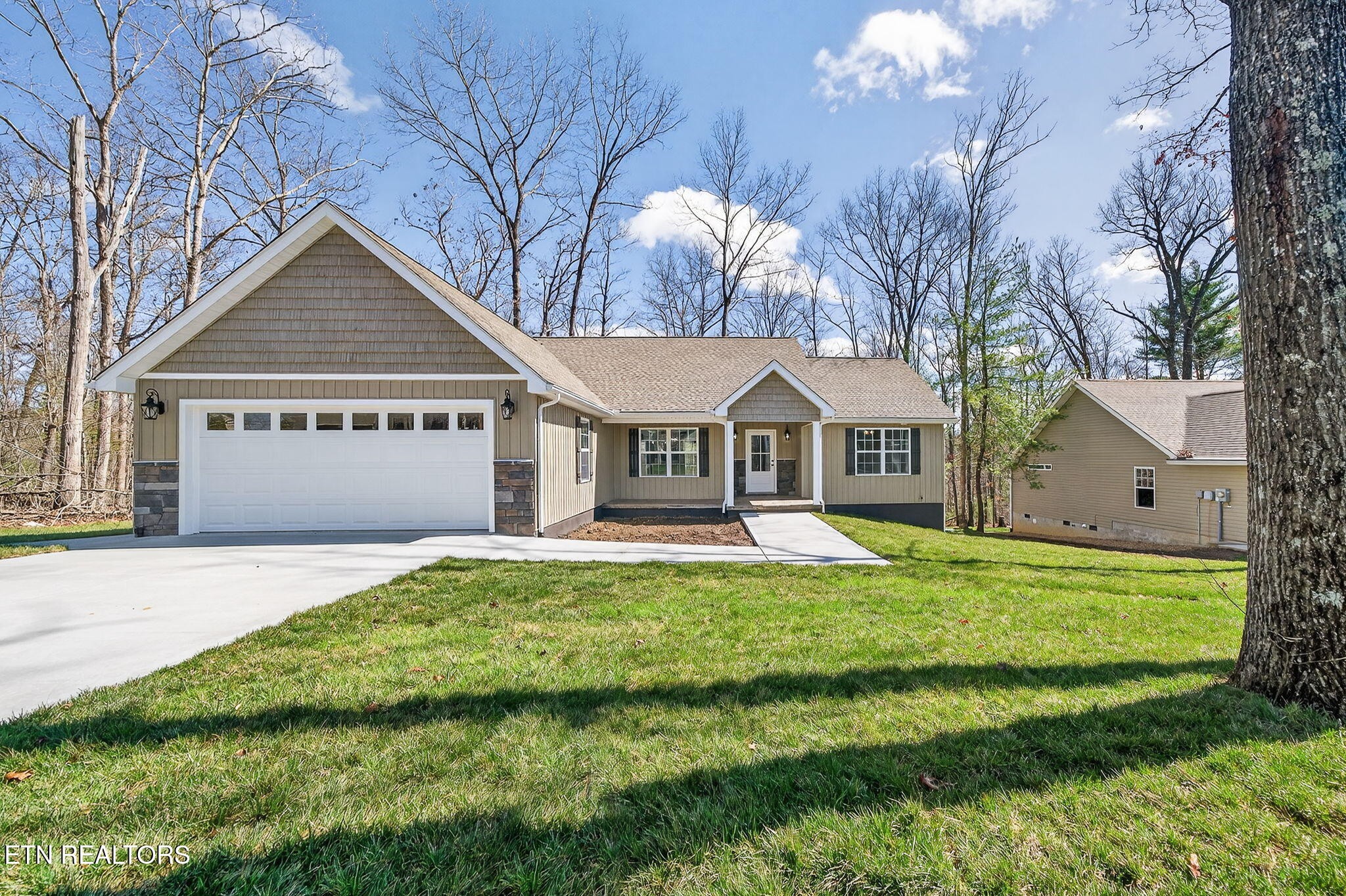105 Peebles Road Crossville, TN 38558 - Photo 29 of 40 a front view of a house with a yard and garage