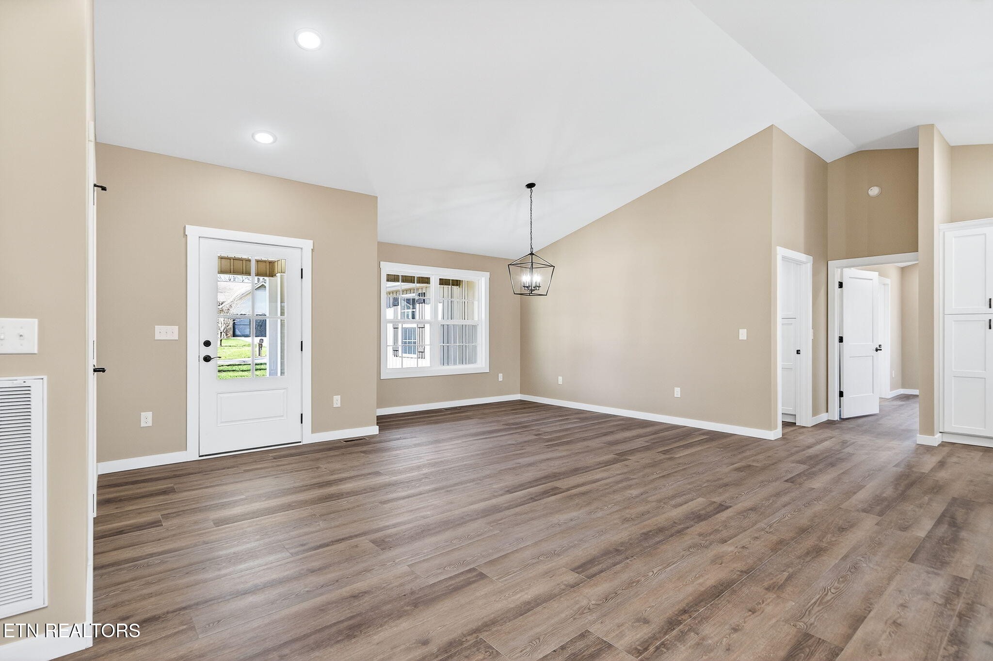 105 Peebles Road Crossville, TN 38558 - Photo 5 of 40 a view of an empty room with wooden floor and a window