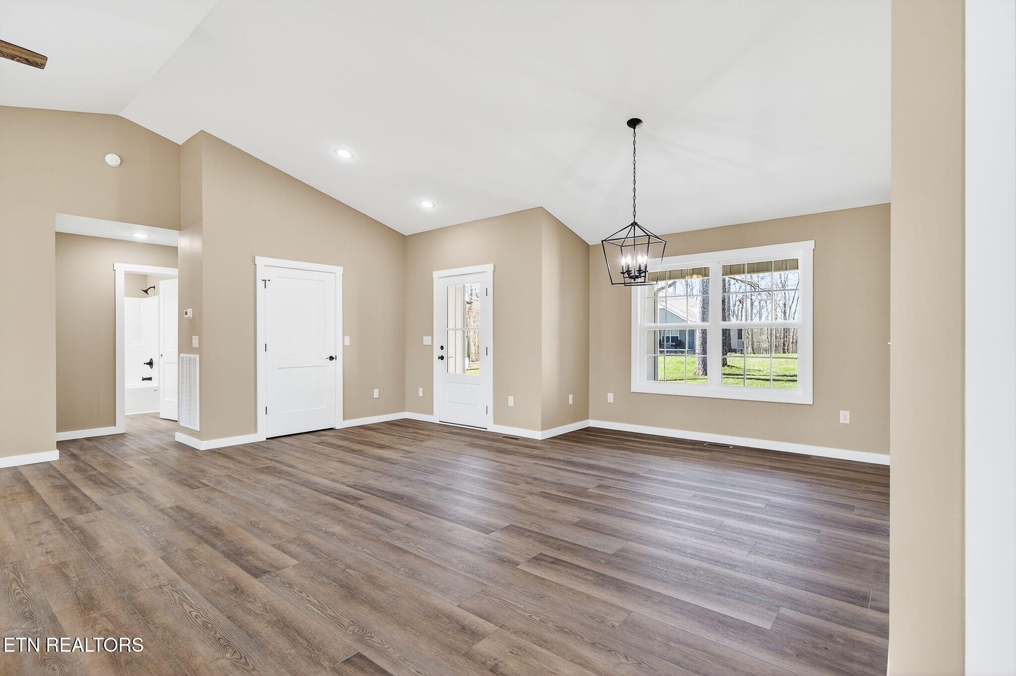 105 Peebles Road Crossville, TN 38558 - Photo 7 of 40 a view of empty room with wooden floor and fan