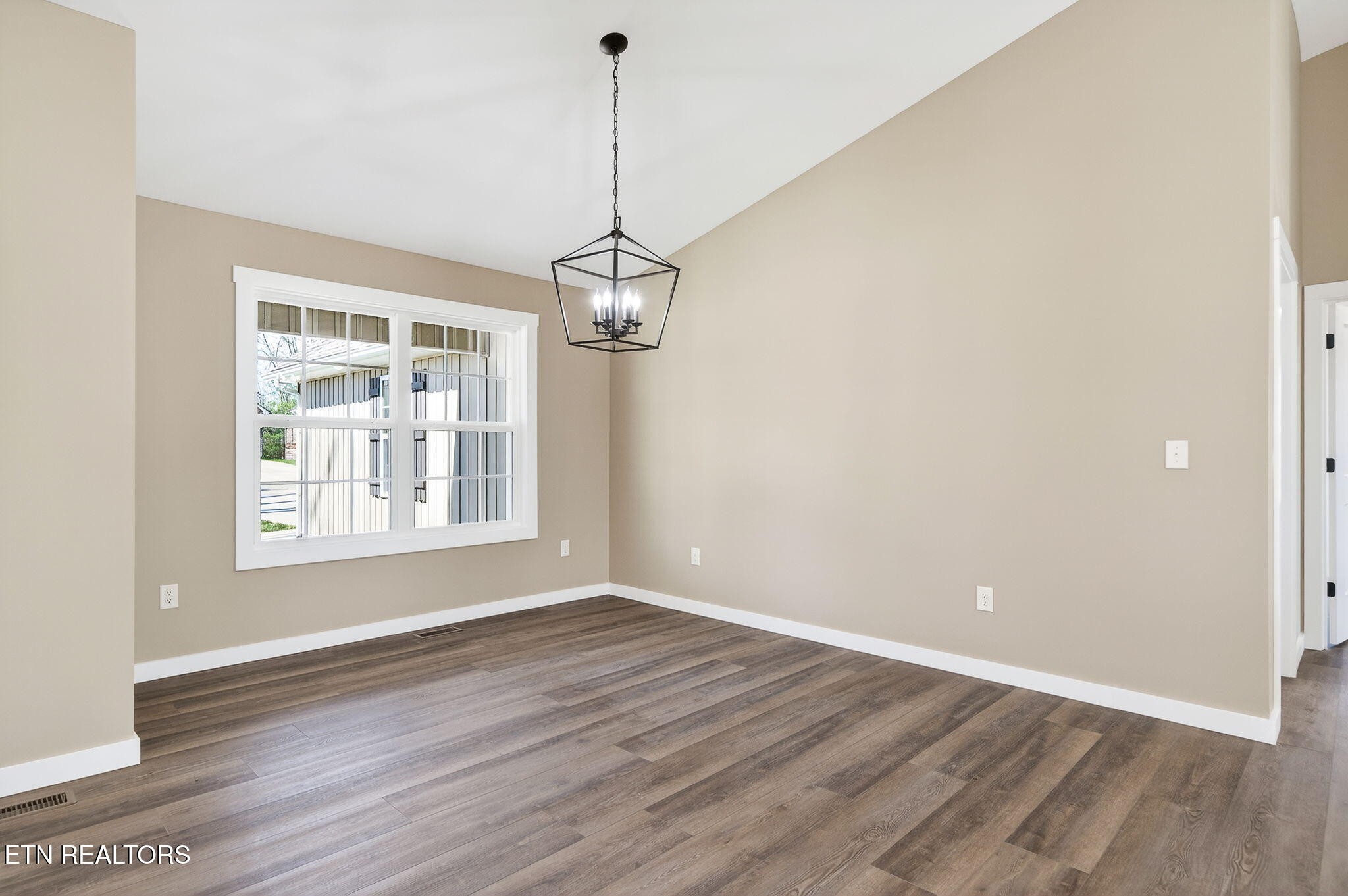 105 Peebles Road Crossville, TN 38558 - Photo 8 of 40 a view of an empty room with wooden floor and a window