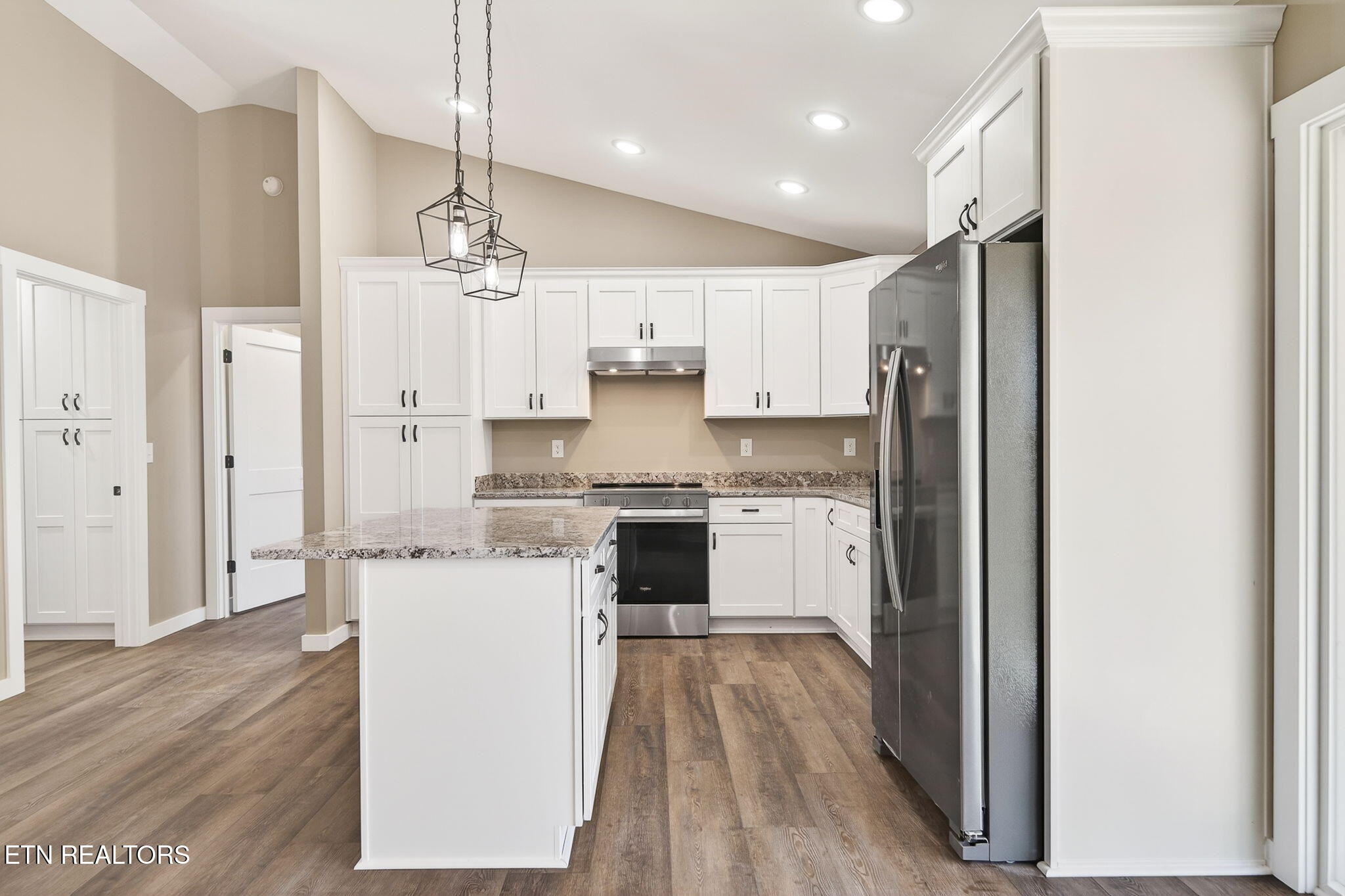 105 Peebles Road Crossville, TN 38558 - Photo 10 of 40 a kitchen with a refrigerator a sink and wooden floor