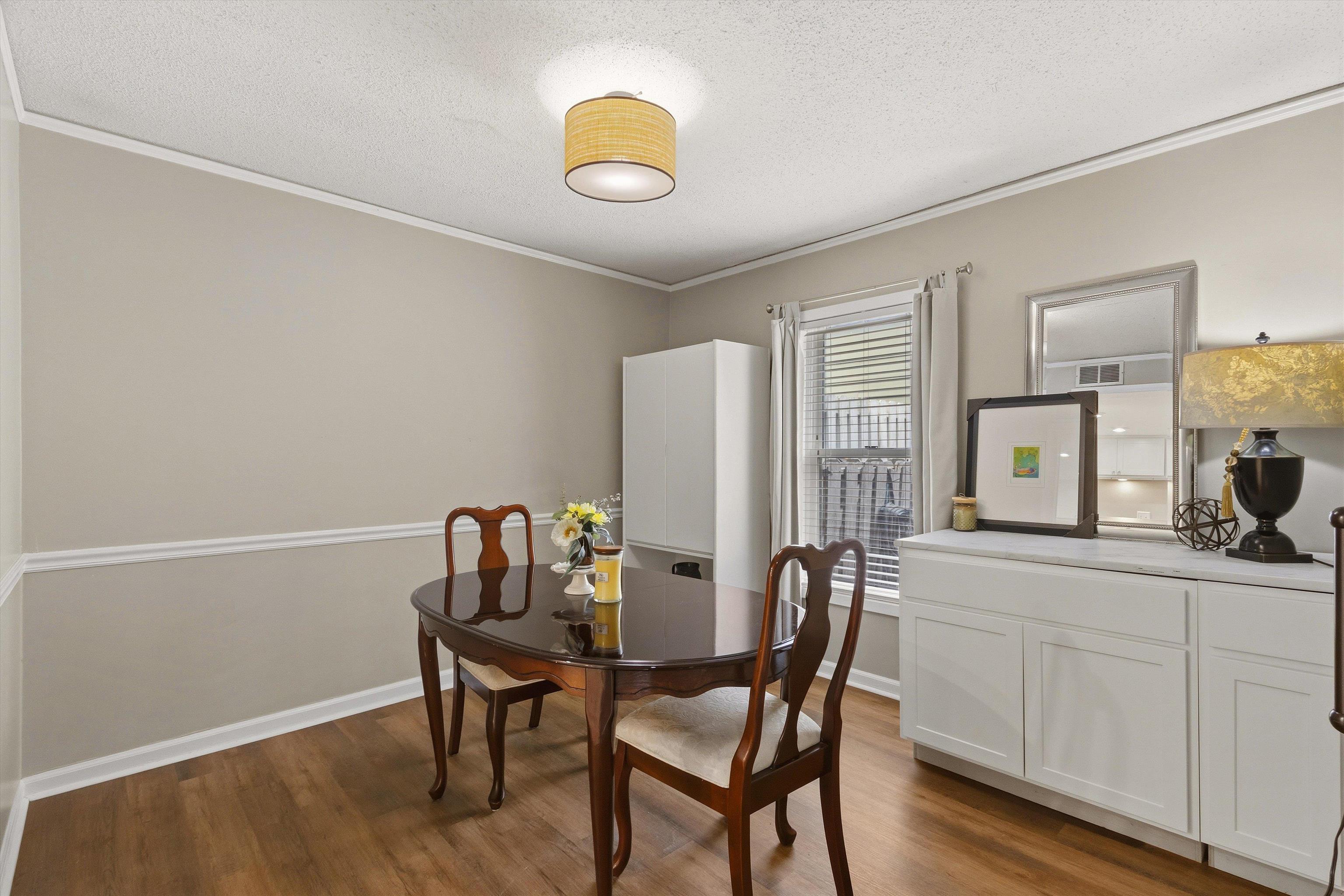 1906 Allenby Road, Unit 16 Germantown, TN 38139 - Photo 12 of 31 Wood-finish flooring, white crown molding, and chair rail detailing