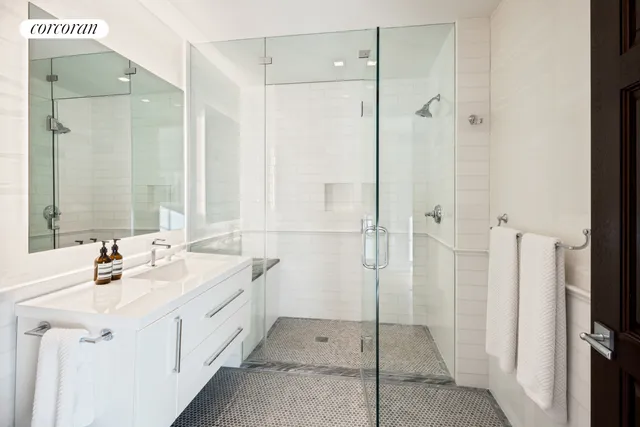 a bathroom with a double vanity sink a mirror and shower