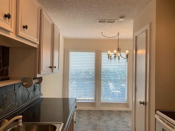 a kitchen with a sink and cabinets