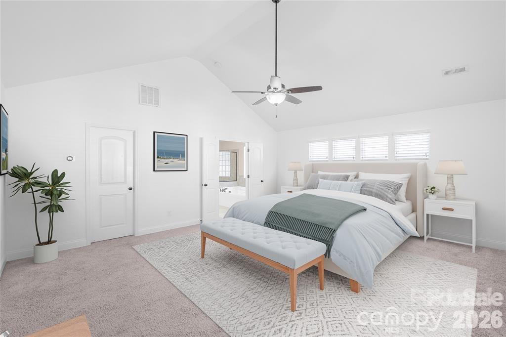 2003 Fallondale Road Waxhaw, NC 28173 - Photo 17 of 31 a bed room with a bed and a chandelier