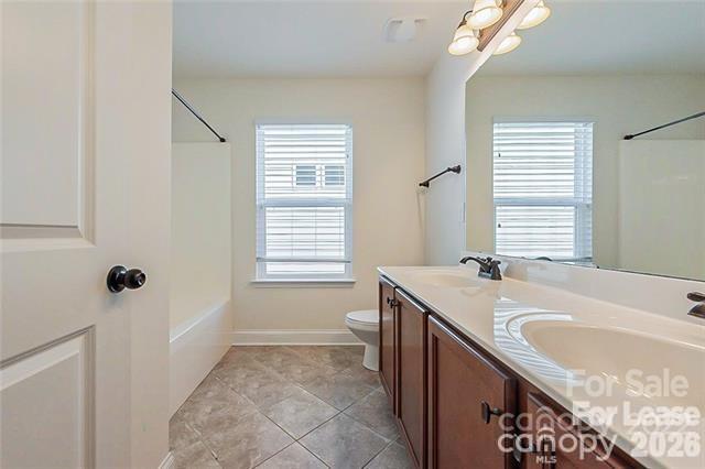 2003 Fallondale Road Waxhaw, NC 28173 - Photo 21 of 31 a bathroom with a granite countertop sink a toilet and shower