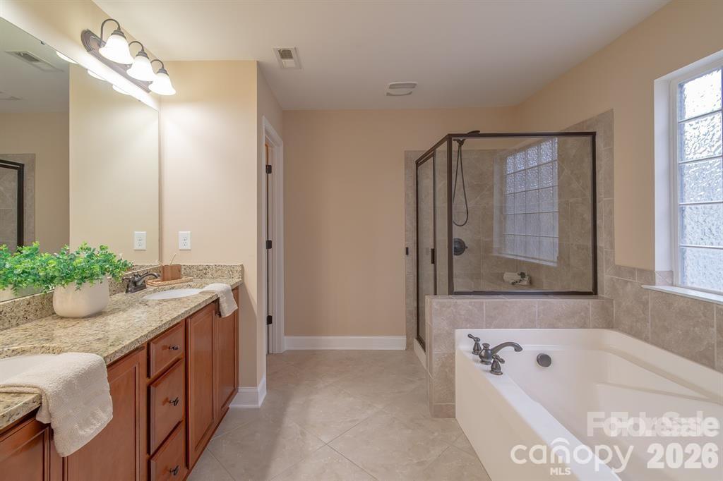 2003 Fallondale Road Waxhaw, NC 28173 - Photo 23 of 31 a bathroom with a tub sink and mirror