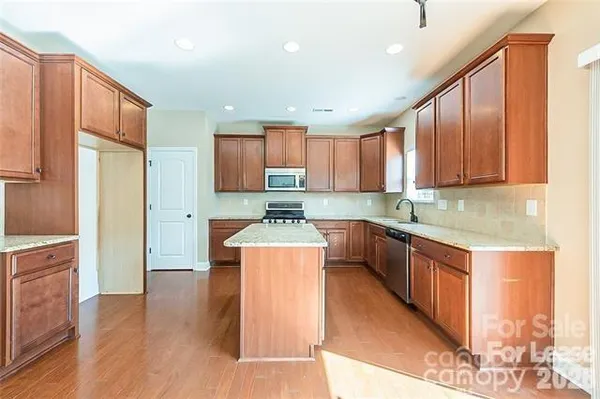 a spacious bathroom with a granite countertop tub sink and mirror
