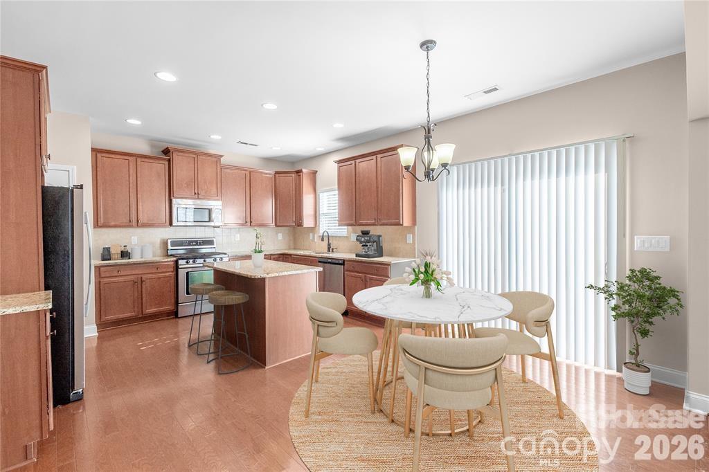 2003 Fallondale Road Waxhaw, NC 28173 - Photo 7 of 31 a kitchen with a dining table chairs and white appliances