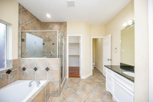 a bathroom with a bathtub and a shower