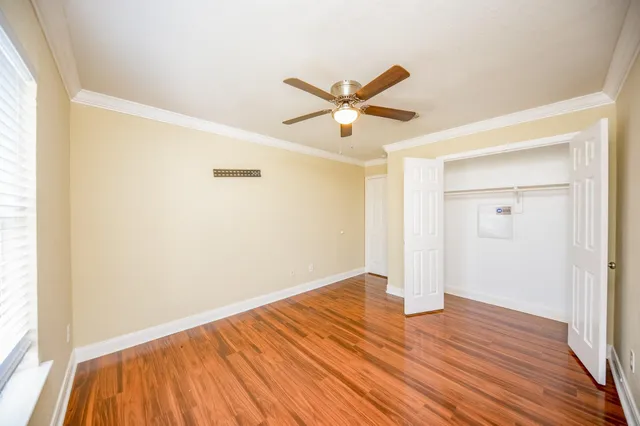 a bedroom with a bed and a ceiling fan