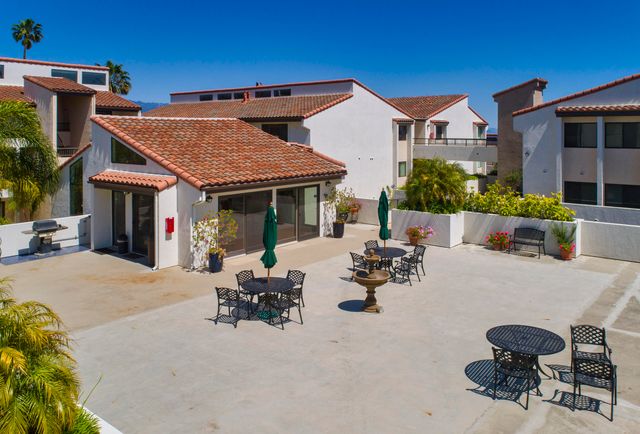 a view of the house with swimming pool and sitting area