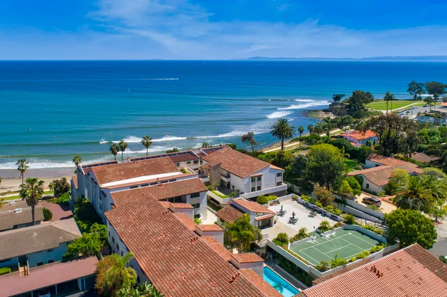 an aerial view of residential houses with outdoor space