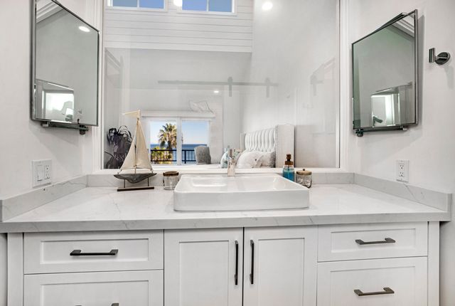 a view with a sink and mirror