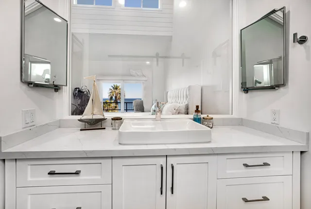 a view with a sink and mirror