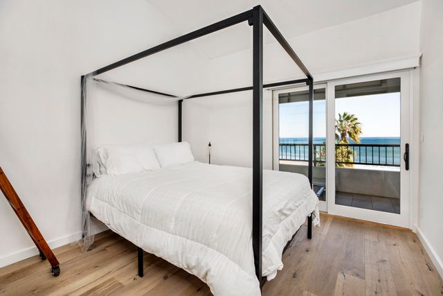 a bedroom with a bed and a mirror