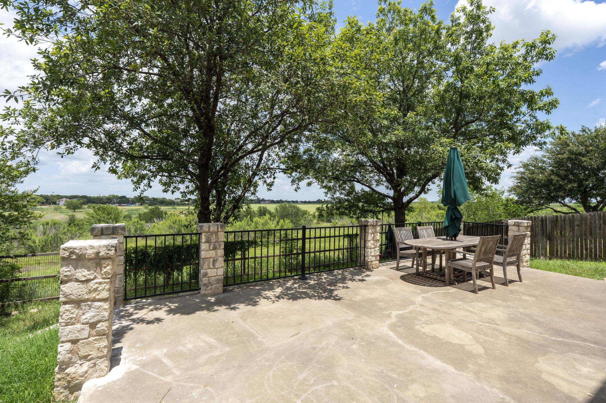 454 Fall Circle Kyle, TX 78640 - Photo 34 of 39 A spacious patio offers serene views of the surrounding landscape, perfect for outdoor entertaining.