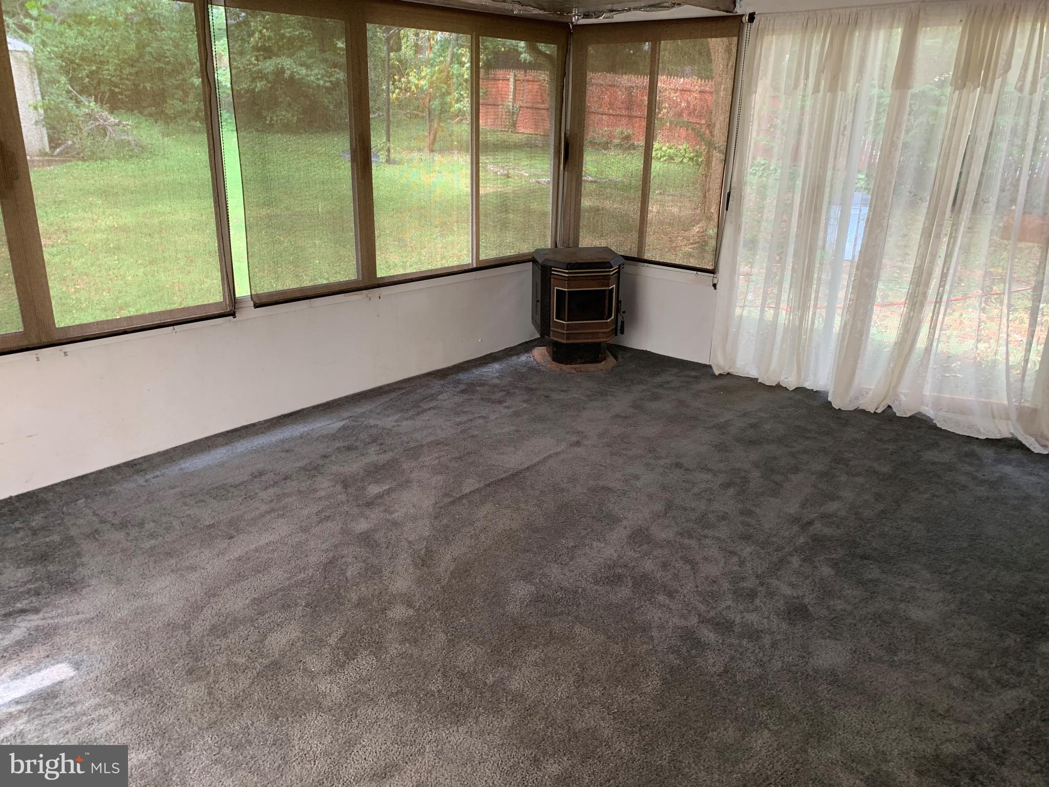 5317 Tolson Road Temple Hills, MD 20748 - Photo 16 of 23 VIEW OF SUNROOM WITH PELLET STOVE