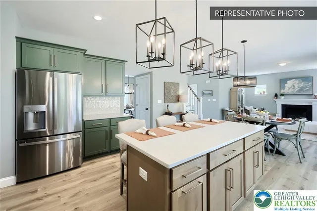 a kitchen that has a lot of cabinets and refrigerator in it