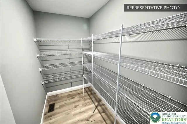 a view of a room with wooden floor and windows