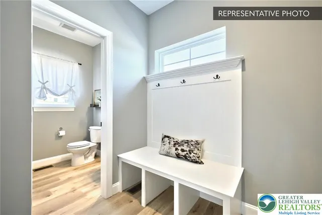 a bathroom with a sink a toilet and a window