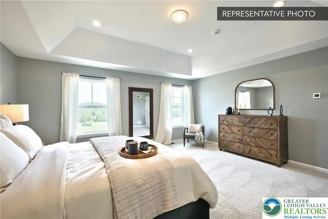 a bedroom with a bed and dresser with mirror