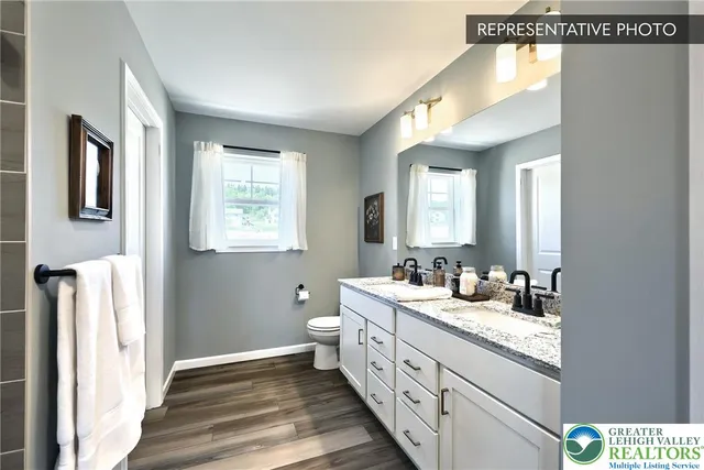 a bathroom with a double vanity sink and a mirror