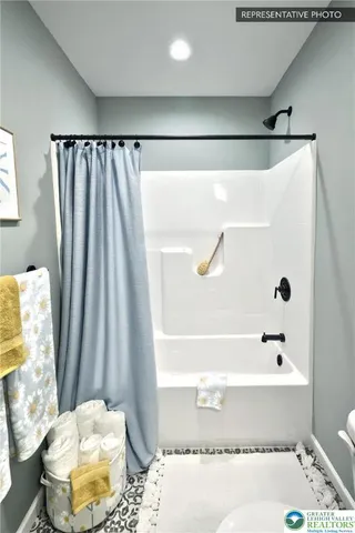 a bathroom with a bathtub and shower