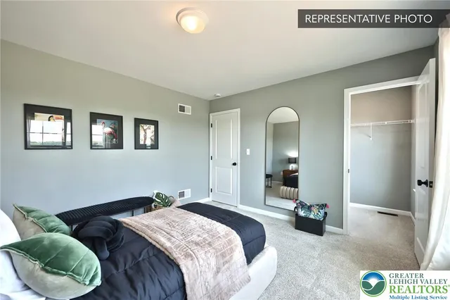 a spacious bedroom with a bed and closet