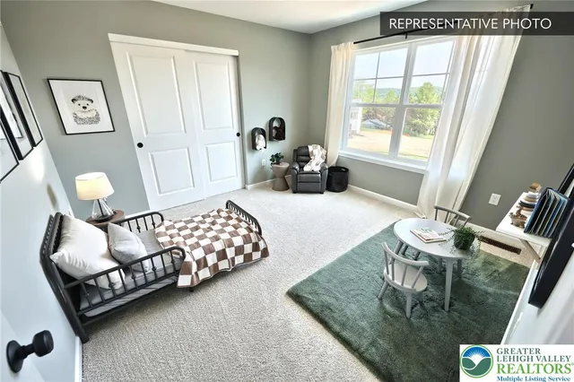 a bedroom with furniture and a large window