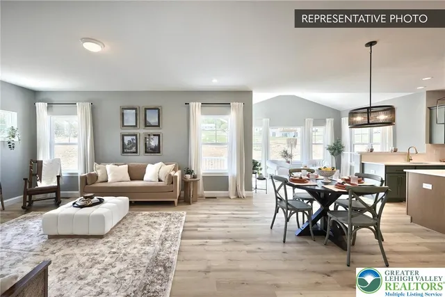 a living room with furniture wooden floor and a large window