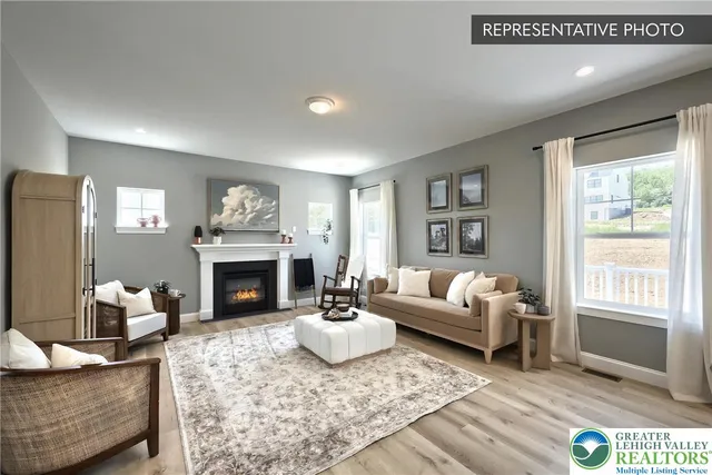 a living room with furniture a fireplace and a window
