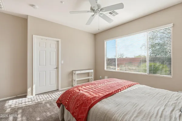 a bedroom with a large bed and a window