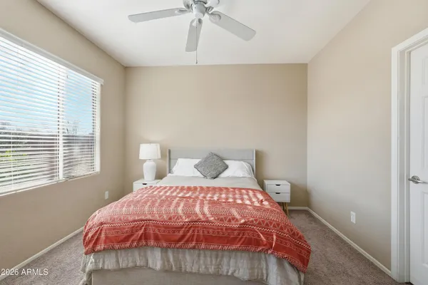 a bedroom with a bed and a window