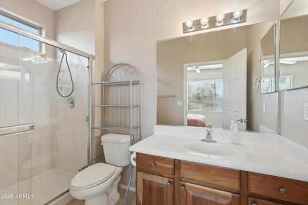 a bathroom with a sink toilet vanity and shower