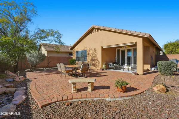 a view of a house with backyard and sitting area