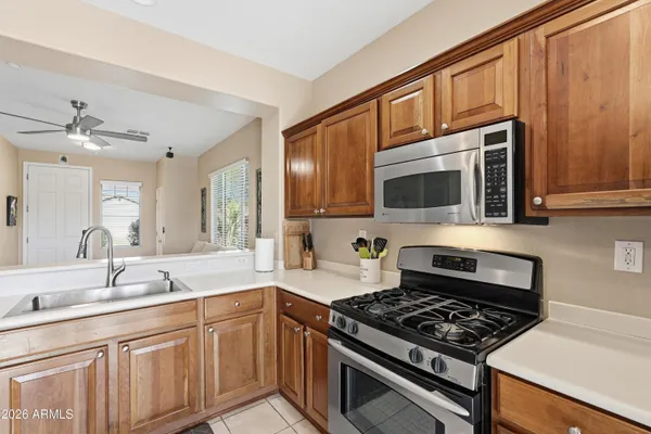 a kitchen with stainless steel appliances a stove a sink and a microwave