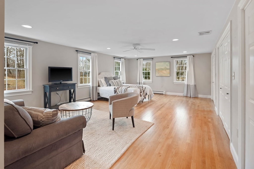 10 Union Street Hingham, MA 02043 - Photo 17 of 40 a living room with furniture a flat screen tv and wooden floor