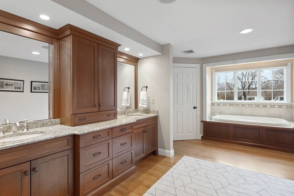 10 Union Street Hingham, MA 02043 - Photo 25 of 40 a spacious bathroom with a granite countertop double vanity sink a mirror and a bathtub