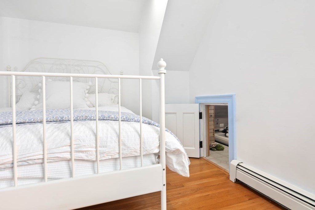 10 Union Street Hingham, MA 02043 - Photo 28 of 40 a large white bed sitting in a room next to a window