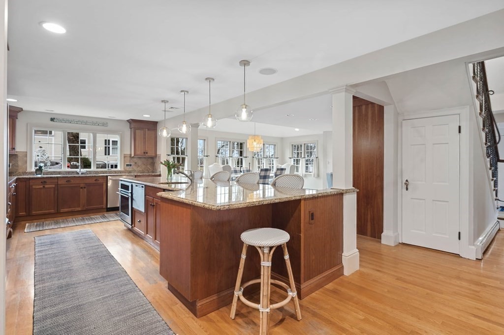 10 Union Street Hingham, MA 02043 - Photo 3 of 40 a large kitchen with stainless steel appliances kitchen island granite countertop a large counter top and wooden floors