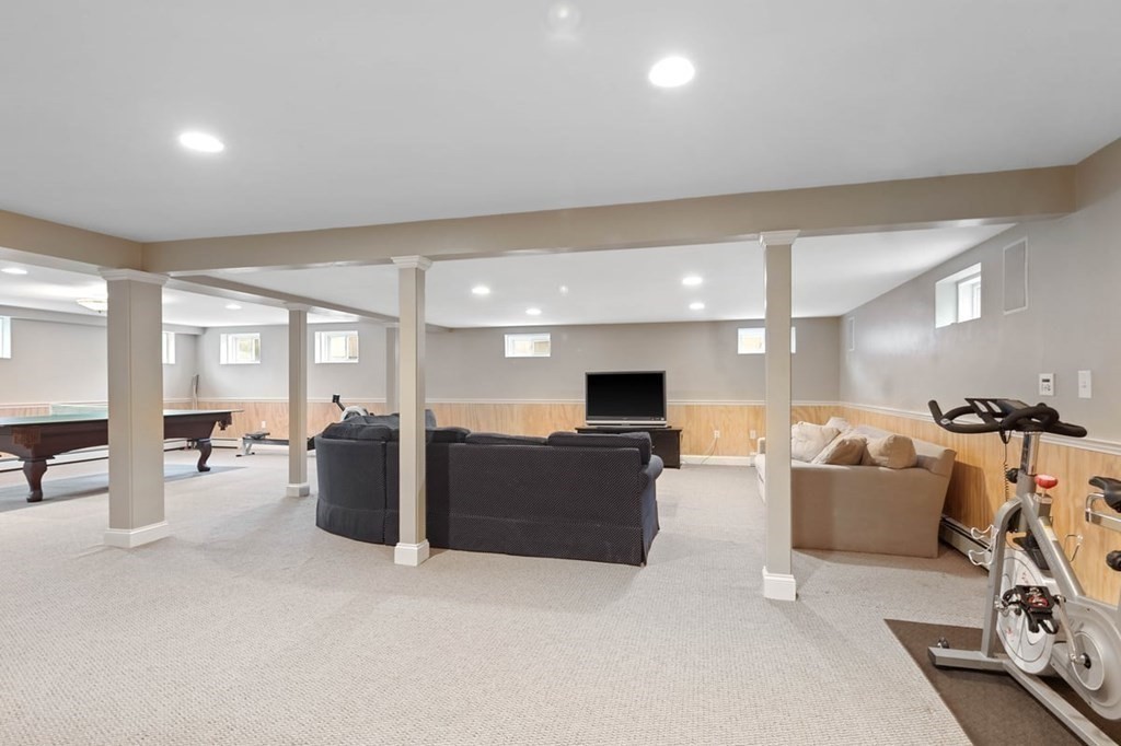 10 Union Street Hingham, MA 02043 - Photo 35 of 40 a living room with furniture a flat screen tv and a table