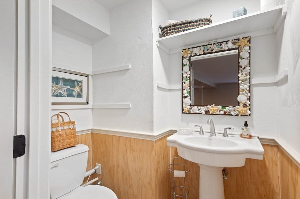 10 Union Street Hingham, MA 02043 - Photo 37 of 40 a bathroom with a toilet a sink and a mirror