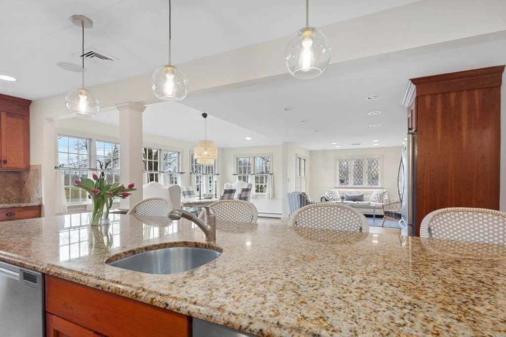 10 Union Street Hingham, MA 02043 - Photo 4 of 40 a large kitchen with granite countertop a sink a counter top space appliances and cabinets
