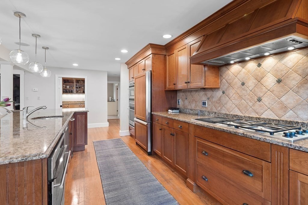 10 Union Street Hingham, MA 02043 - Photo 5 of 40 a kitchen with stainless steel appliances granite countertop a stove a sink and a refrigerator