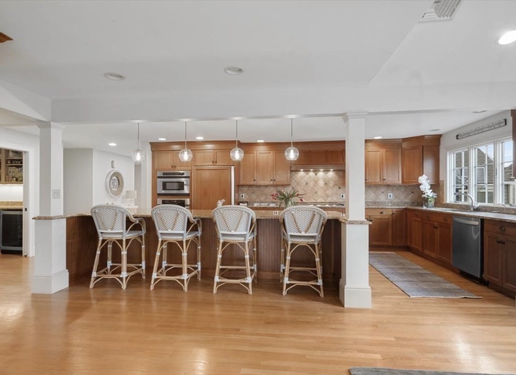 10 Union Street Hingham, MA 02043 - Photo 7 of 40 a dining room with wooden floor stainless steel appliances and chandelier