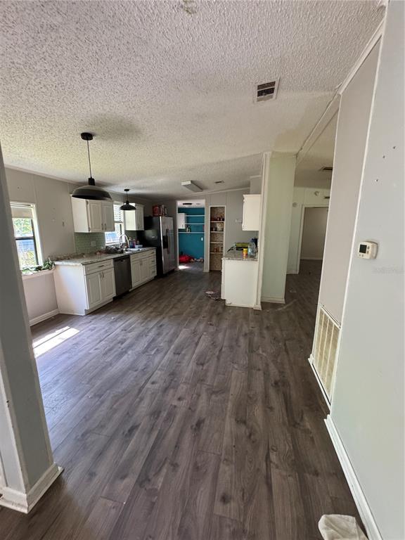 4266 County Road 691 Webster, FL 33597 - Photo 16 of 22 wooden floor and dining room with furniture